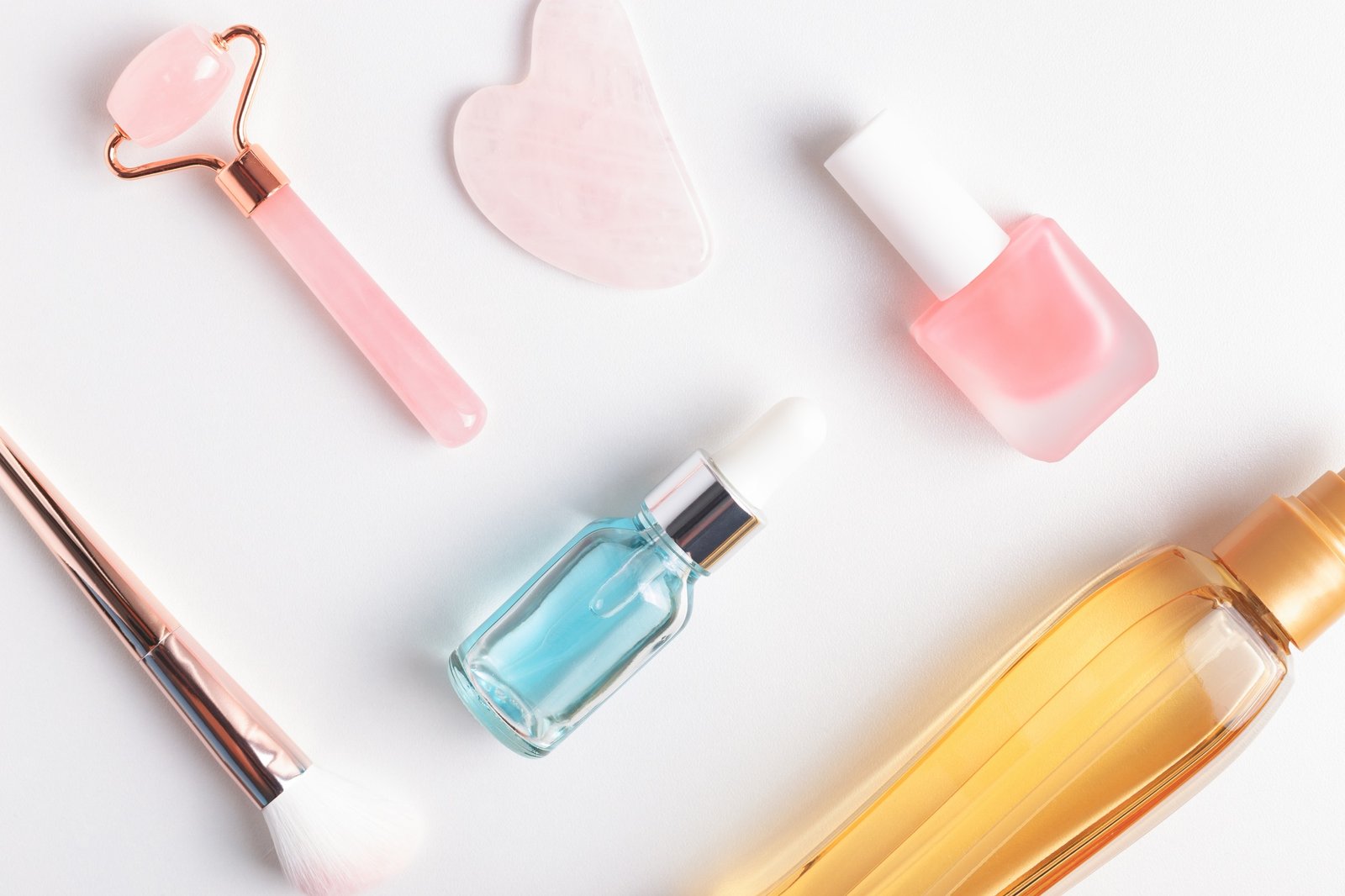Beauty and personal care products laying over white table.
