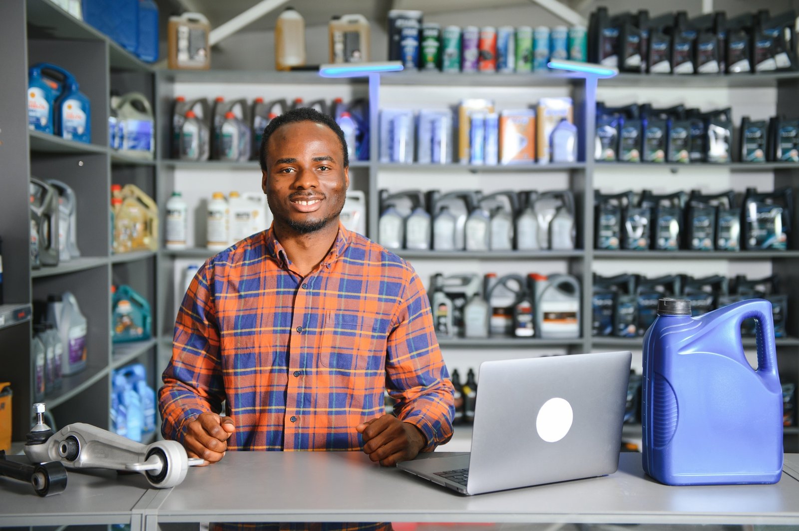 friendly worker in a warehouse and trade for car spare parts of a car repair shop